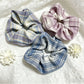 Close-up of Gifty simple vintage plaid scrunchie in beige and brown tones