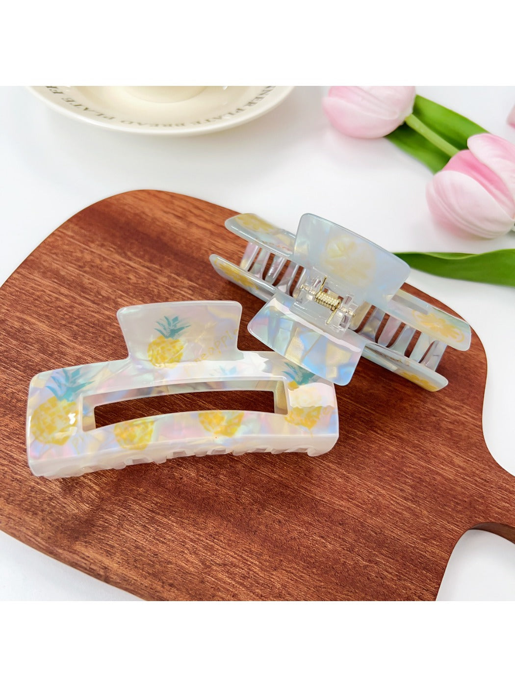 Close-up of Beau claw clip showing detailed fruit designs including strawberries and oranges
