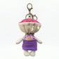 Keypus fabric doll keychain displayed alongside other accessories on a table