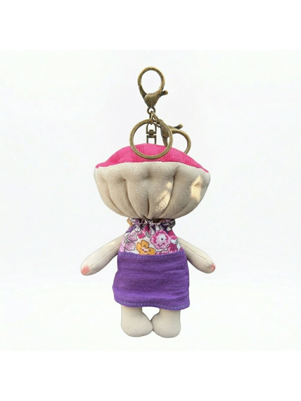 Keypus fabric doll keychain displayed alongside other accessories on a table