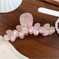 Beau floral half round claw clip angled to show both floral design and clasp