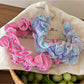 Close-up of Gifty ruffle pleated fabric headband in soft pink color