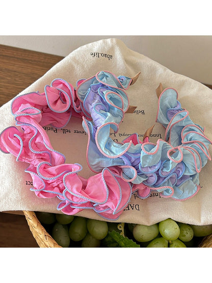 Close-up of Gifty ruffle pleated fabric headband in soft pink color