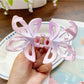 Beau hair claw clip holding a section of brown hair in a half-up style
