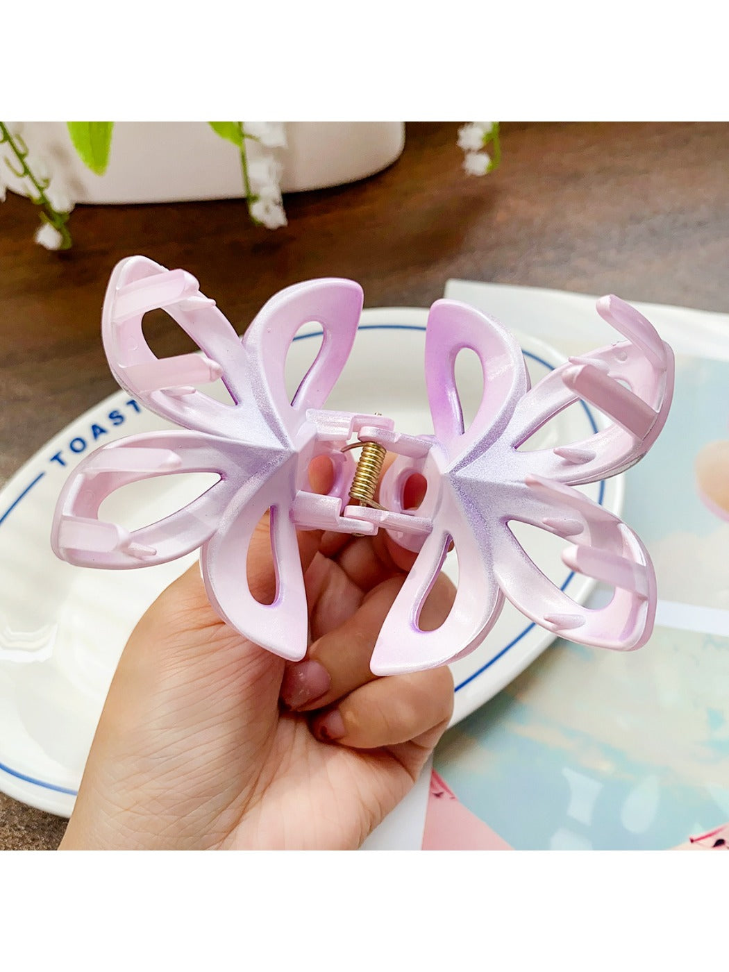 Beau hair claw clip holding a section of brown hair in a half-up style