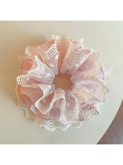 Close-up of Gifty sweet printed ruffled scrunchie with pastel floral pattern