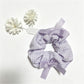 Gifty Sweet Bow Embellished Plaid Scrunchie worn on wrist with visible bow and plaid design