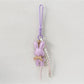 Bunny keychain hanging from a set of keys on a wooden table