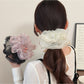 Gifty ruched scrunchie worn on a ponytail showcasing its solid color and texture