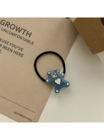 Rose hair tie stretched to show elastic quality and flower detail