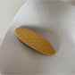 Beau pink hair clip with white dots placed next to matching accessories