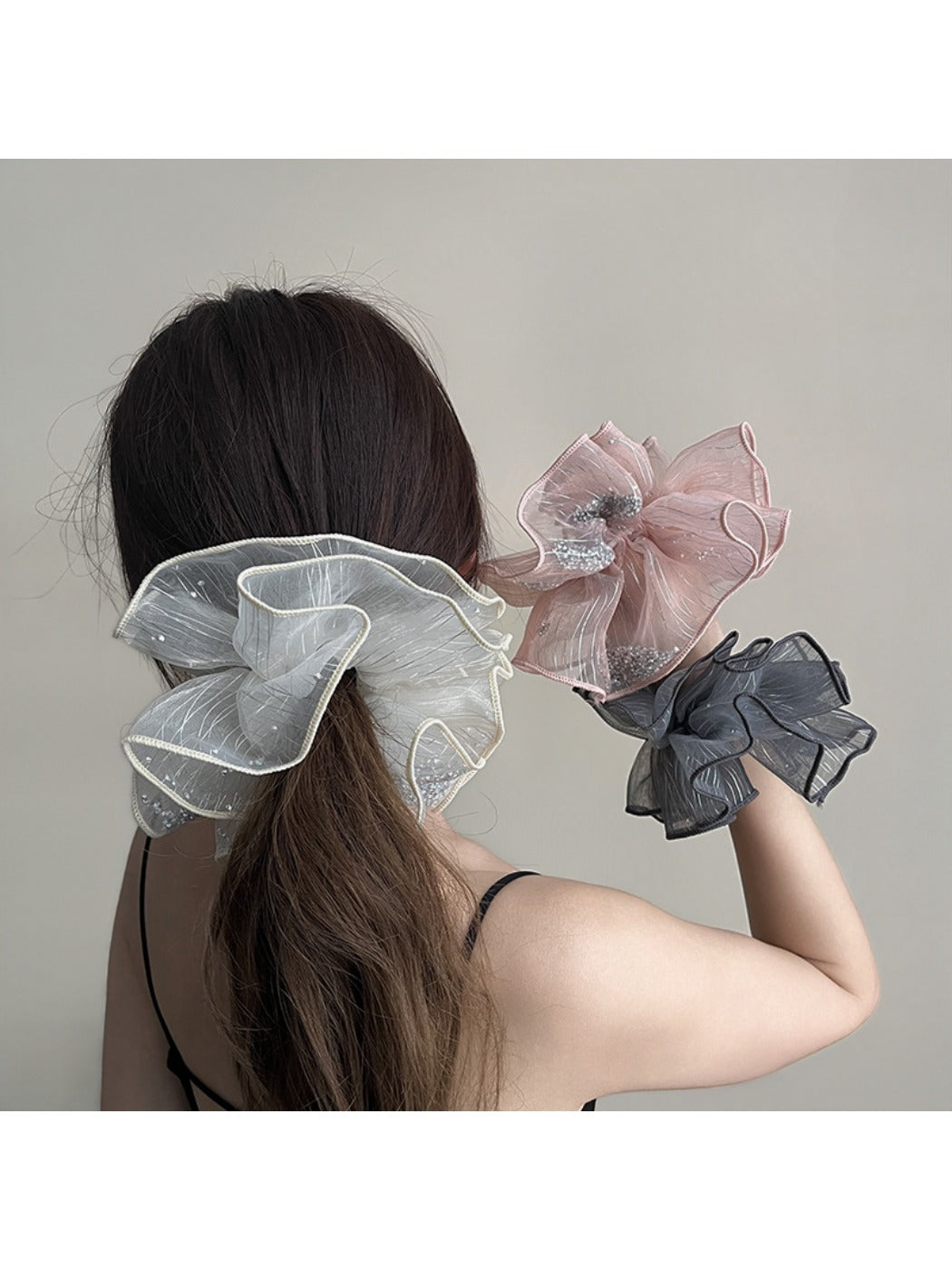 Close-up of Gifty scrunchie showing detailed ruched fabric layers in pink
