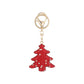Red Christmas tree keychain on white background