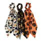 Three Halloween ribbon scrunchies on white background
