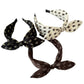 White black and brown paisley rabbit ear headbands on white background
