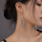 Earedge - Snake Wrapped Cross Drop Earrings