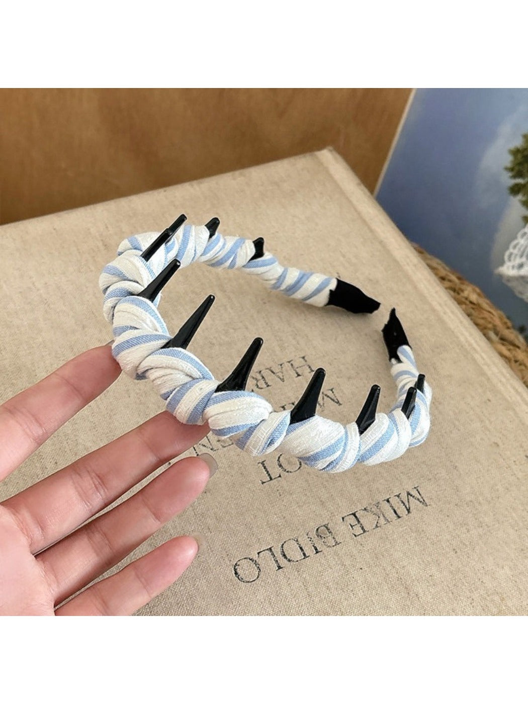 Gifty checkered headband styled with vintage accessories on wooden surface