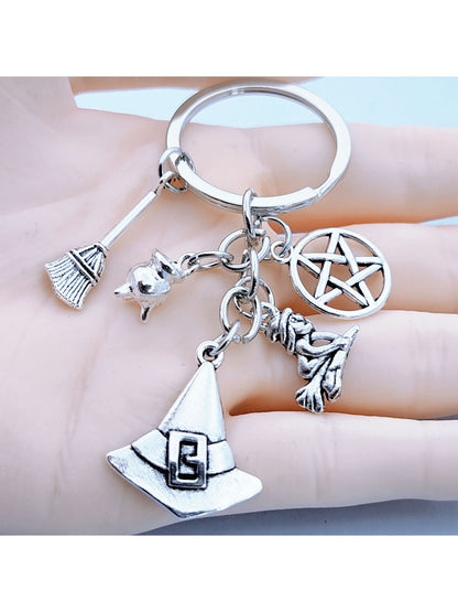 Close-up of silver alloy witch hat keychain with detailed broom charm