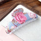 Beau hair clip placed on a white background displaying bright flower motifs