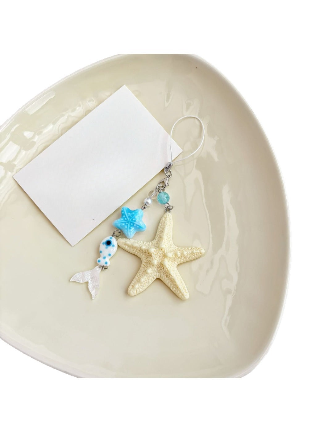 Starfish keychain displayed on a wooden surface with natural lighting