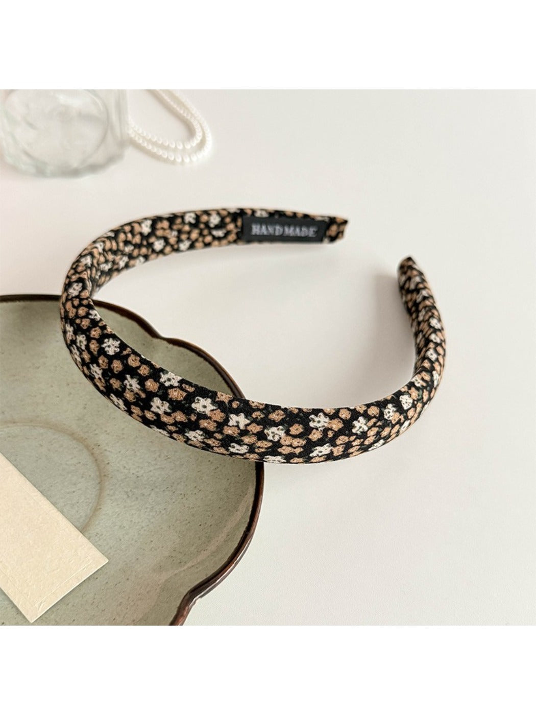 Folded Gifty fabric headband displaying tiny floral design