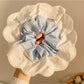 Flat lay of large plaid ruffle scrunchie on white background