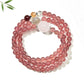 Lovra pink crystal bead bracelet coiled to show multiple layers and gold accent beads