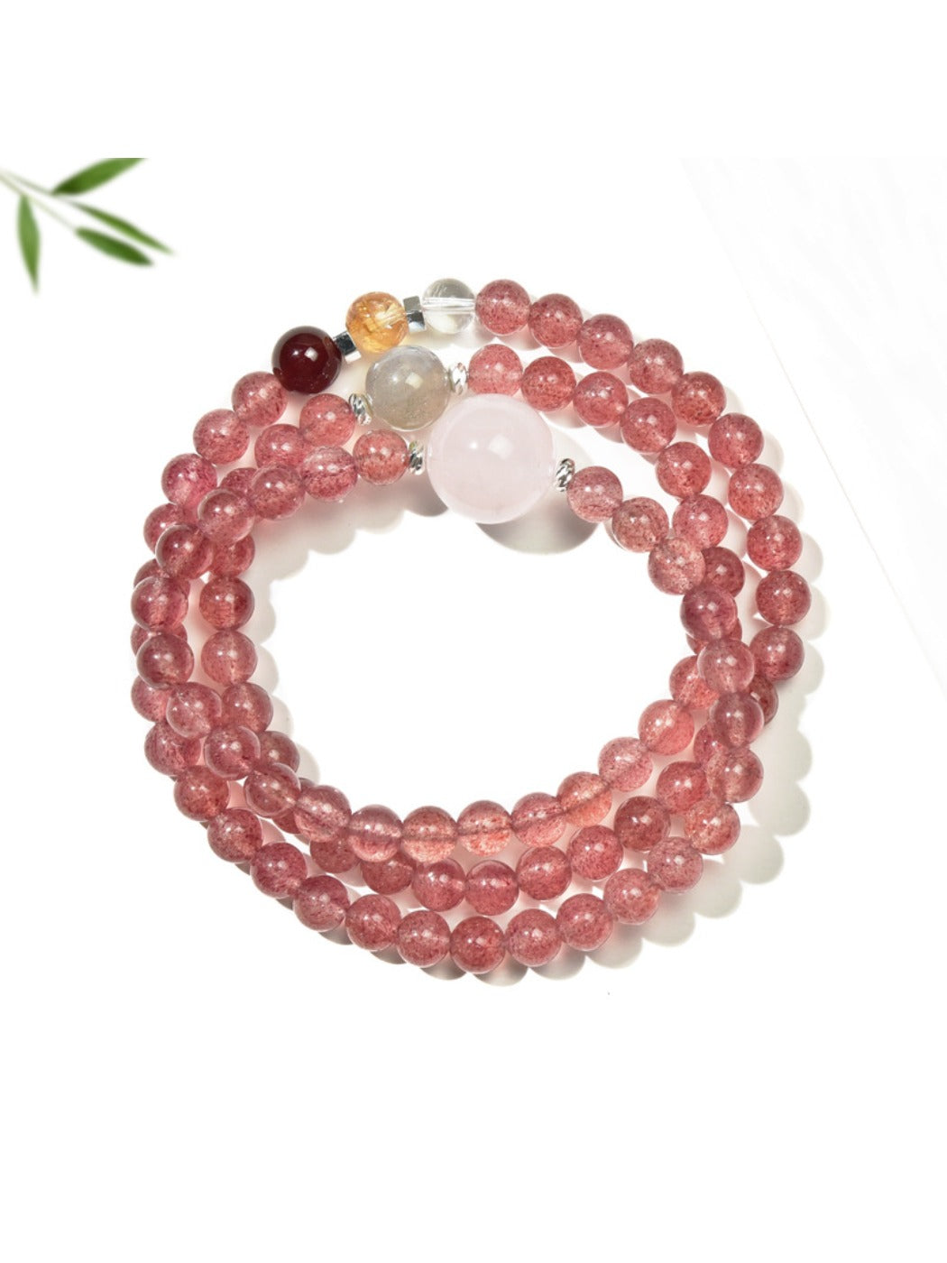 Lovra pink crystal bead bracelet coiled to show multiple layers and gold accent beads
