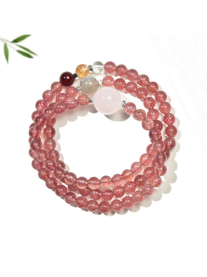 Lovra pink crystal bead bracelet coiled to show multiple layers and gold accent beads