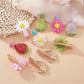 Close-up of Beau raffia strawberry flower hair clip showing woven texture and details