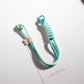 Hand holding a colorful twisted rope keychain with metal ring