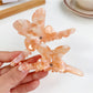 Side view of Beau bow adorned hair claw clip highlighting curved teeth