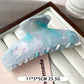 Beau plastic updo claw clip shown from above, highlighting its oval shape