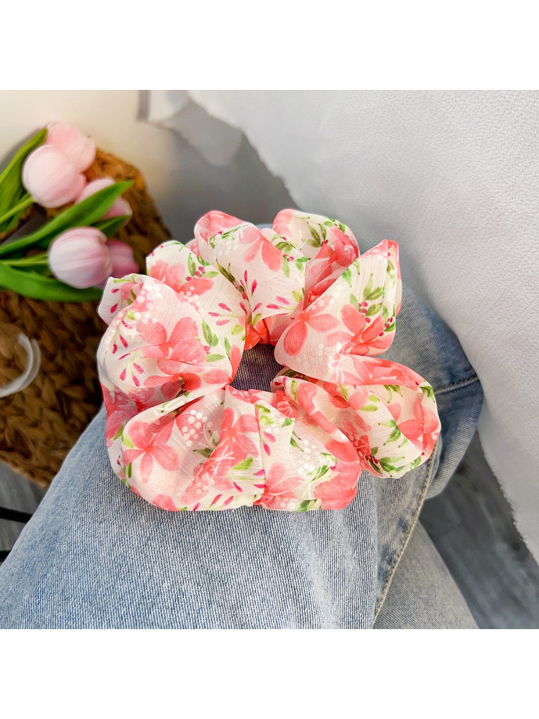 Red floral bow scrunchie displayed flat showing bow detail