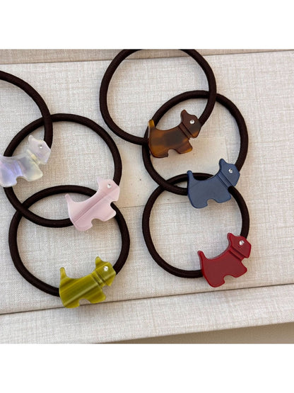Gifty hair tie featuring a smiling cartoon puppy charm on a black elastic band
