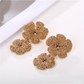 Close-up of the raffia texture on Earedge floral pendant drop earrings