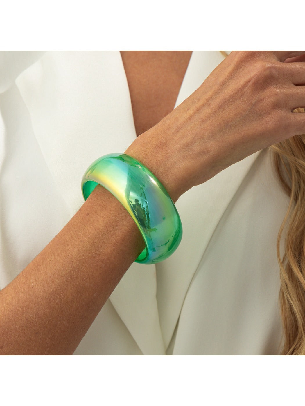 Lovra minimalist colorful bangle bracelet on a reflective surface