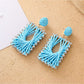 Close-up of woven raffia detail on square shape drop earrings
