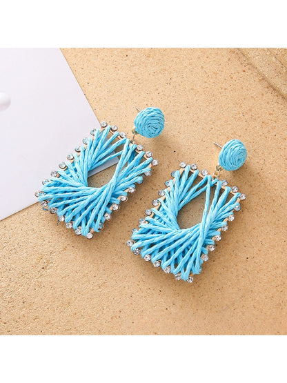 Close-up of woven raffia detail on square shape drop earrings