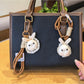 Little bunny shaped bag charm keychain in soft pastel pink with gold keyring