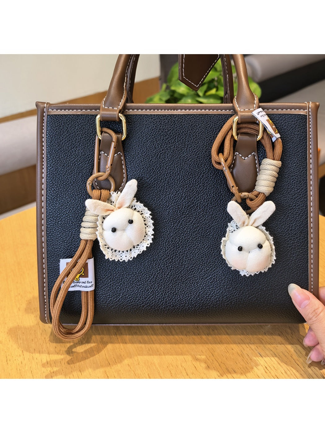 Little bunny shaped bag charm keychain in soft pastel pink with gold keyring