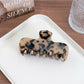 Beau minimalist square hair claw clip photographed with soft natural lighting