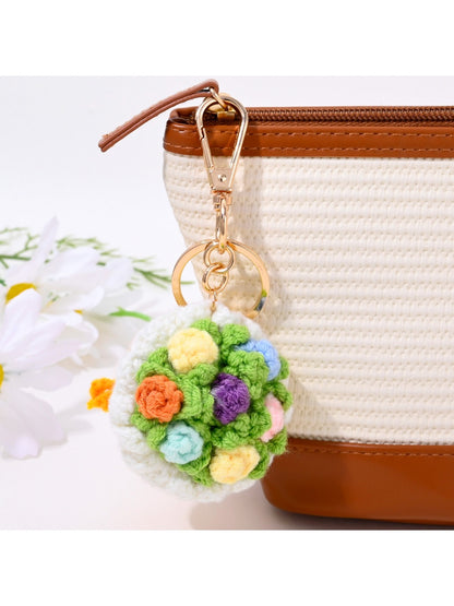 Hand holding Keypus tulip shaped keychain with metal ring attached