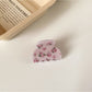 Beau pink rose print hair claw clip styled in hair from side angle