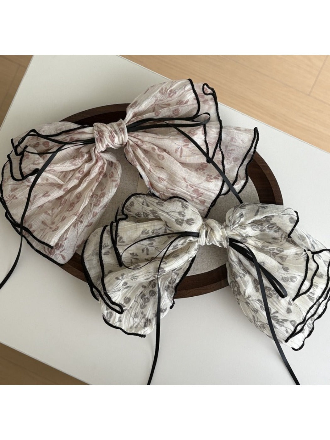 Beau tiny floral bow shape hair clip with pink and white flowers on a gold base