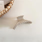 Beau polka dot acetate hair clip held in hand to show size and scale