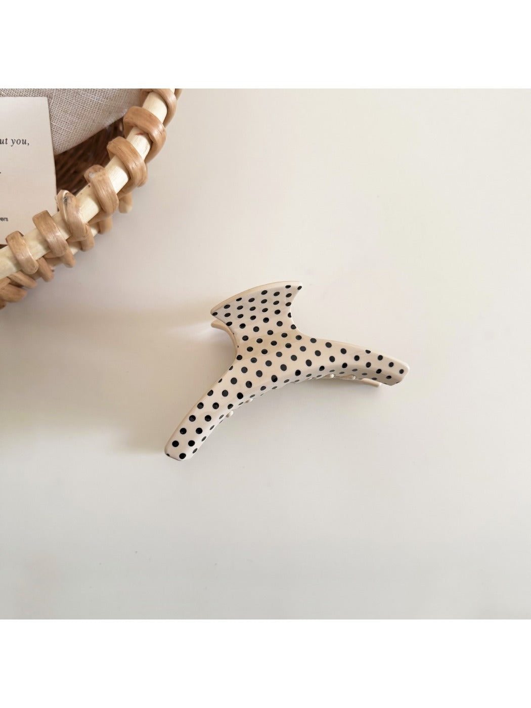 Beau polka dot acetate hair clip held in hand to show size and scale