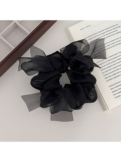 Side view of Gifty bow accented scrunchie showing fabric texture