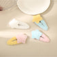 Close-up of Beau fluffy star shaped hair clip in soft beige color