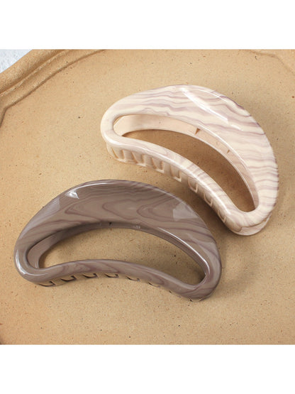 Close-up of Beau semi circular hollow hair clip showing smooth curved design